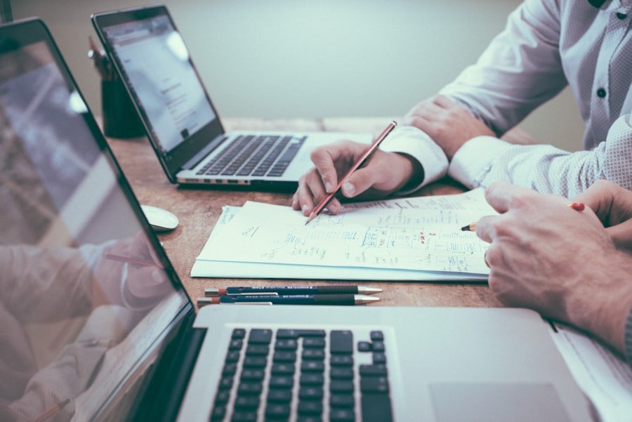 Accountant reviewing figures near a laptop